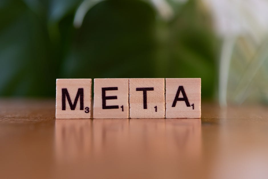 pexels-photo-30885770-30885770 Wooden letter blocks spell META on a table with a blurred green background.